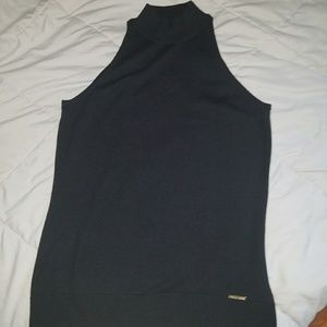 Michael Korrs sleeveless mock turtleneck.